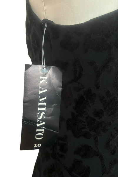Detail showing the still attached tag of new with tags 1990s vintage Art Deco style black floral burnout velvet knit maxi dress, by Kamisato, small to medium.