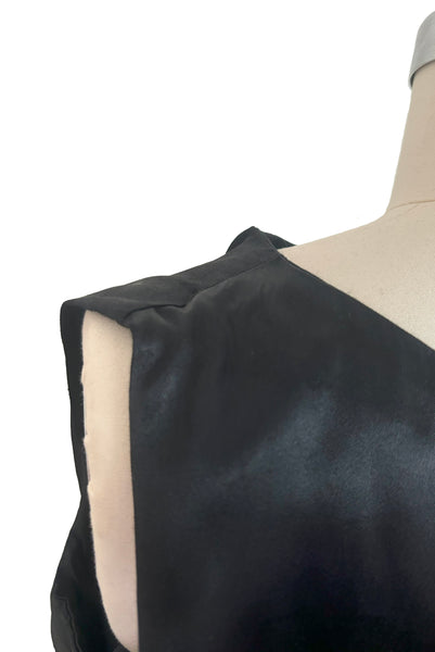 Back detail view of 1960s does 1920s vintage black satin and lace flapper dress costume, small to medium. Showing some scuffing to the satin near the shoulder.