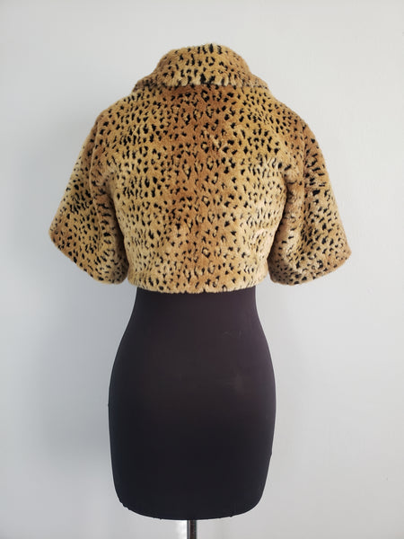 The Leslie Courreges Anita Bolero features recessed leopard spots against golden faux fur.