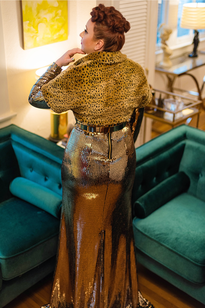 The Leslie Courreges Anita Bolero features recessed leopard spots against golden faux fur.
