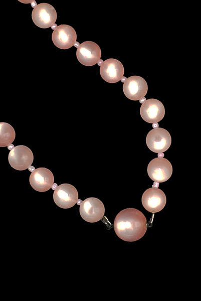 Detail view of 1960s vintage long pink moonglow Lucite graduated bead necklace. Showing a close-up of the hidden slide clasp. 