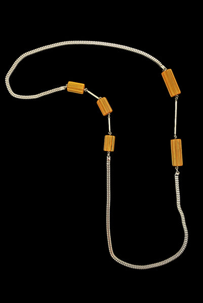 Vertical view of 1930s vintage marbled butterscotch Bakelite beads and chrome silver tone chain necklace.