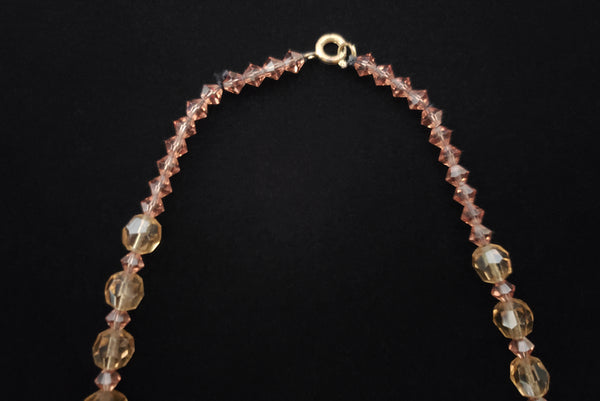 Detail view of 1960s vintage smokey topaz mauve graduated crystal bead and silver tone rhinestone spacer long necklace. Showing the bicone beads that were added by the clasp.