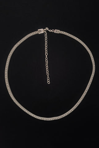 Vertical top view of 1960s vintage adjustable silver tone metal mesh and rhinestone chain belt with floral hook, size medium to large.