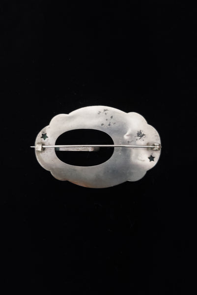 Vertical back view of 1900s vintage turn of the century 925 sterling silver iris floral sash buckle brooch.