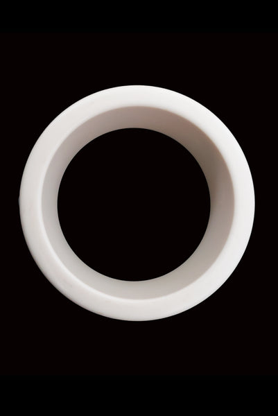 Vertical top view of 1960s vintage white Lucite plastic sliced bangle bracelet with raised gray marbled dots.