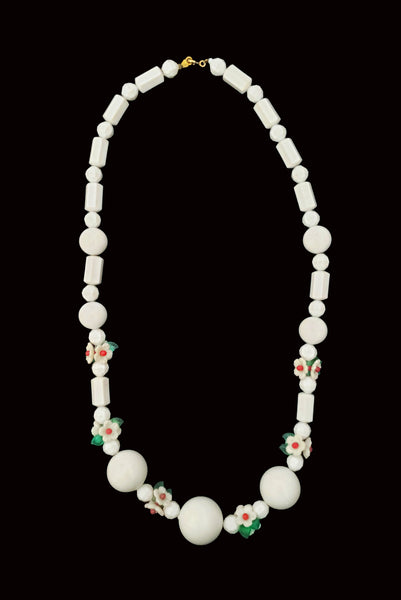 Vertical view of 1960s vintage green, red, and white floral bead plastic long necklace.