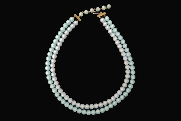 Horizontal view of 1960s vintage double strand moonglow Lucite two tone blue adjustable necklace.