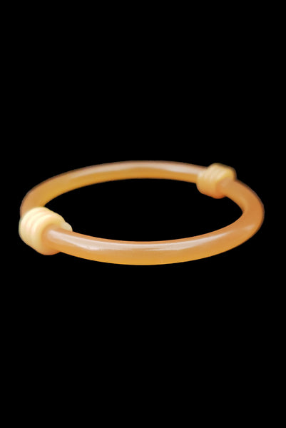 Vertical front view of 1960s vintage translucent mustard yellow plastic tube bangle bracelet with wrapped phone cord detailing.