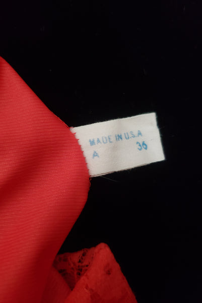 Interior detail view of 1950s vintage crimson red nylon and lace full slip by Van Raalte, small to medium. Showing the size 36, made in the USA tag.