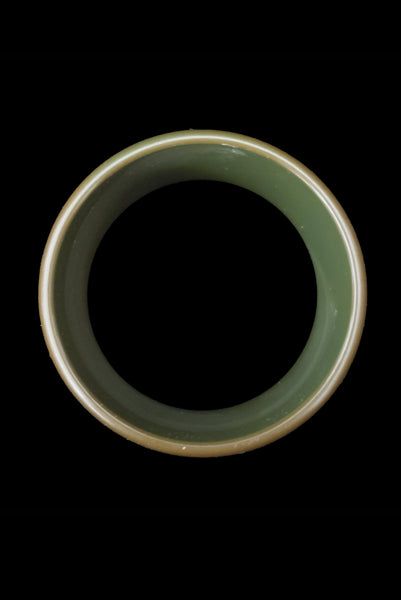 Vertical top view of 1930s vintage green floral carved Bakelite bangle bracelet.