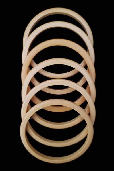 Vertical top view of 1930s vintage set of six (6) corn mustard yellow Bakelite spacer bangle bracelets.