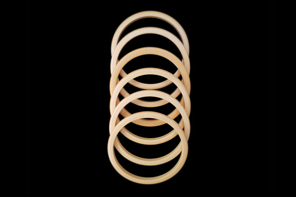 Horizontal top view of 1930s vintage set of six (6) corn mustard yellow Bakelite spacer bangle bracelets.