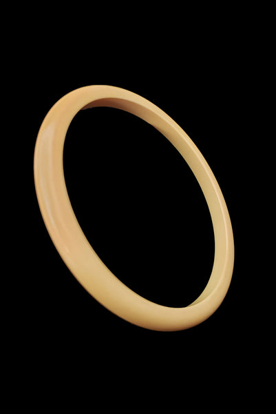 Vertical perspective view of 1930s vintage set of six (6) corn mustard yellow Bakelite spacer bangle bracelets.