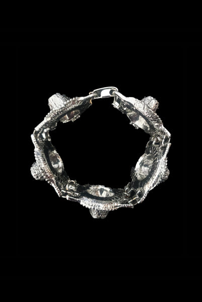 Vertical top view of 1960s vintage blue, green, orange, red, and purple multicolor rhinestone silver tone sombrero hat bracelet by PA.