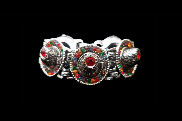 Horizontal front view of 1960s vintage blue, green, orange, red, and purple multicolor rhinestone silver tone sombrero hat bracelet by PA.