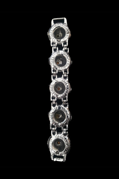 Vertical back view of 1960s vintage blue, green, orange, red, and purple multicolor rhinestone silver tone sombrero hat bracelet by PA.