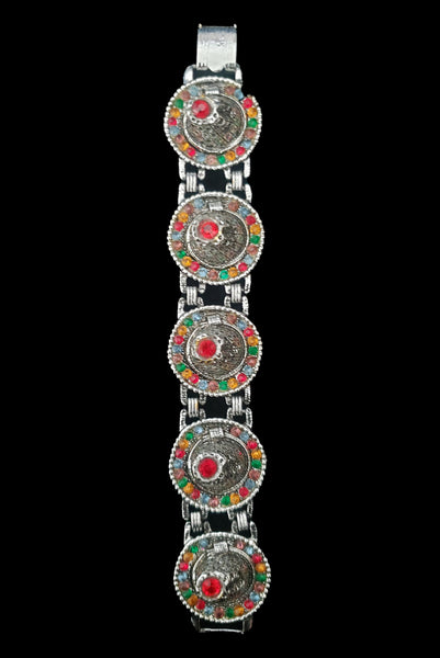 Vertical front view of 1960s vintage blue, green, orange, red, and purple multicolor rhinestone silver tone sombrero hat bracelet by PA.