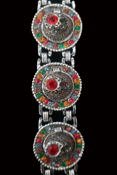 Detail view of 1960s vintage blue, green, orange, red, and purple multicolor rhinestone silver tone sombrero hat bracelet by PA.