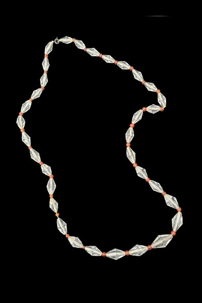 Vertical view of 1920s vintage graduated bicone clear crystal bead necklace with orange amber colored round glass spacers.