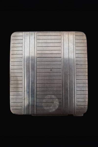 Vertical bottom view of 1920s vintage square silver tone stripe engraved make-up compact.