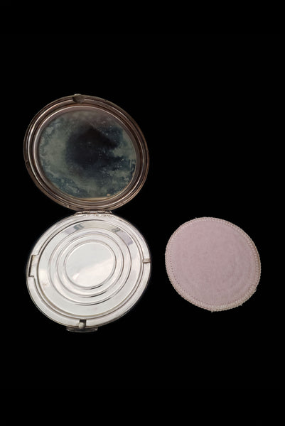 Vertical open view of 1950s vintage round sterling silver Aztec calendar engraved make-up compact. Showing the clean powder puff.