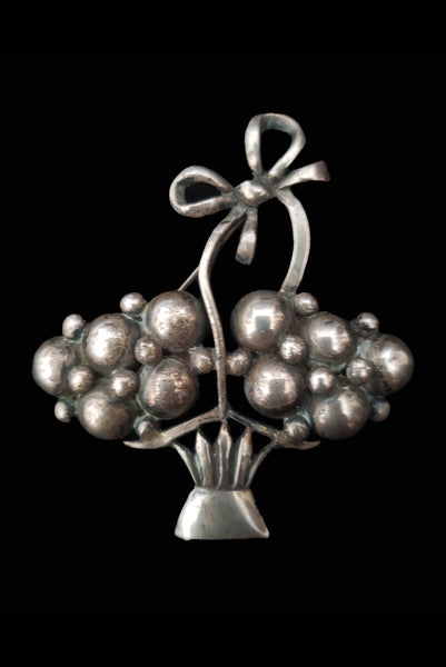 Vertical front view of 1920s vintage 925 sterling silver modernist flower basket brooch.