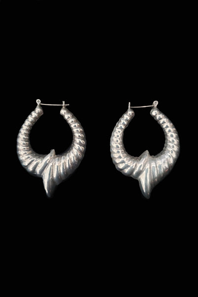Vertical side view of 1980s vintage 925 sterling silver hollow cast large pointed hoop earrings.
