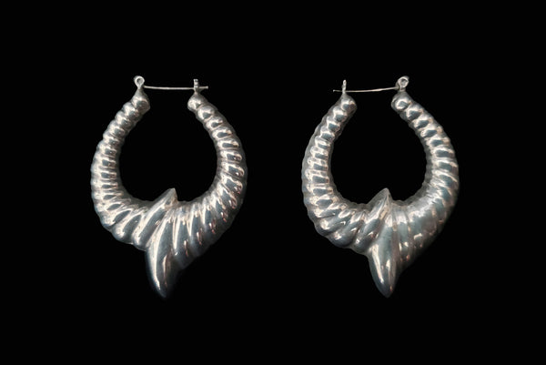 Horizontal side view of 1980s vintage 925 sterling silver hollow cast large pointed hoop earrings.