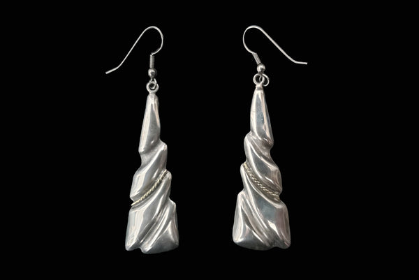 Horizontal front view of 1980s vintage Taxco two-tone 925 sterling silver and brass triangular fish hook pierced drop earrings.