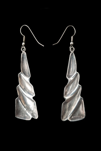 Vertical back view of 1980s vintage Taxco two-tone 925 sterling silver and brass triangular fish hook pierced drop earrings.