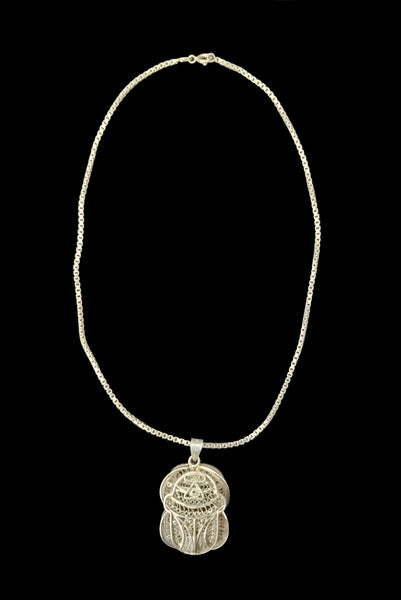 Vertical front view of 1970s vintage silver filigree Egyptian scarab insect pendant on matching box chain.