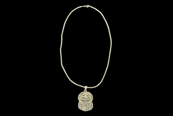 Horizontal front view of 1970s vintage silver filigree Egyptian scarab insect pendant on matching box chain.