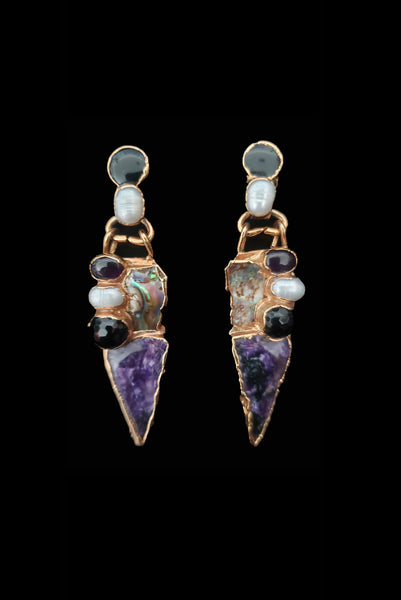 Vertical front view of 1980s vintage gold tone freeform onyx, pearl, amethyst, and mother of pearl pierced statement earrings.