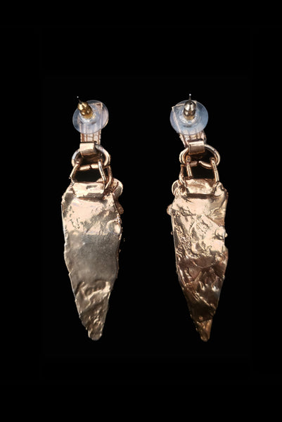Vertical back view of 1980s vintage gold tone freeform onyx, pearl, amethyst, and mother of pearl pierced statement earrings.