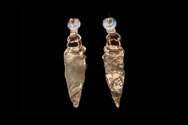 Horizontal back view of 1980s vintage gold tone freeform onyx, pearl, amethyst, and mother of pearl pierced statement earrings.