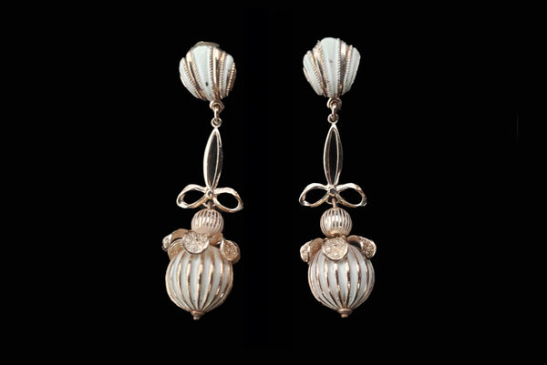 Horizontal front view of 1960s vintage champagne gold metal and white painted beaded drop clip-on earrings by Globus.
