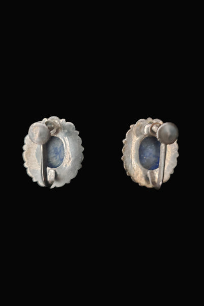 Vertical back view of 1950s vintage blue lapis lazuli oval cabochon and silver filigree screwback earrings.