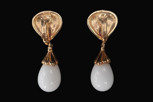 Horizontal back view of 1980s vintage black enamel, oval pink rhinestones, clear rhinestones, white plastic drop, and gold tone metal pierced lever back earrings, by Nina Ricci.