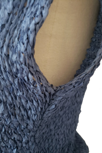 Detail view of 1950s vintage periwinkle rayon ribbon crochet dress, medium to extra large. Showing slight yellowing at the underarm.