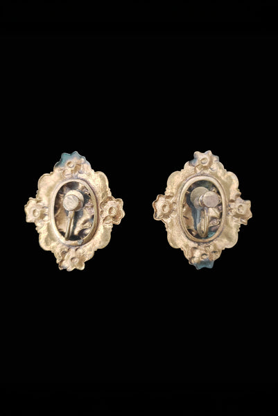 Vertical back view of 1940s vintage rust carnelian oval cabochon in a brass filigree setting unpierced screw back earrings.