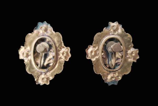 Horizontal back view of 1940s vintage rust carnelian oval cabochon in a brass filigree setting unpierced screw back earrings.
