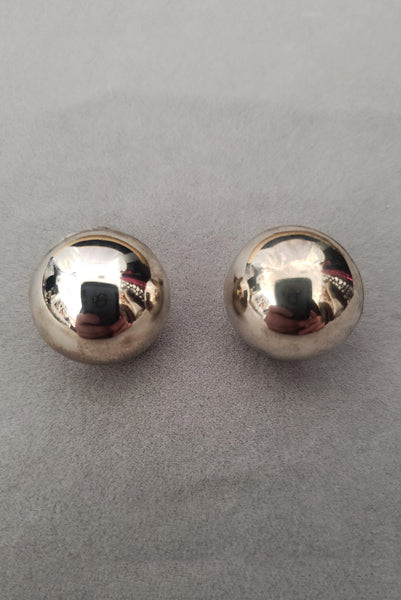 Vertical front view of 1950s vintage 925 sterling silver ball half round screw back earrings.