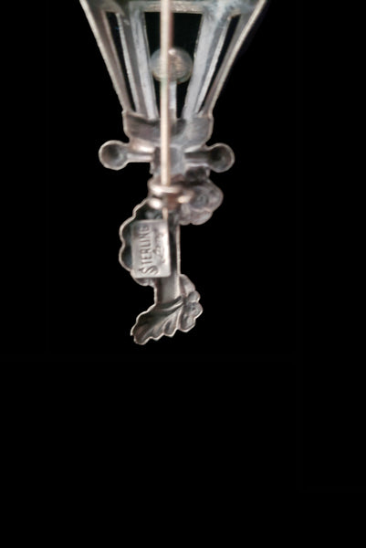 Detail view of 1950s vintage 925 sterling silver and orange rhinestone lamppost brooch by Lang. Showing the Lang Sterling mark.
