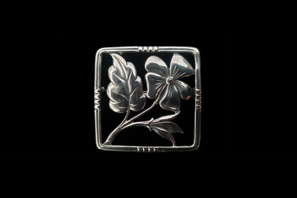 Horizontal front view of 1950s vintage 925 sterling silver square flower brooch.