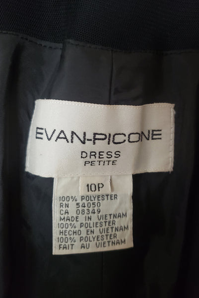 Interior detail view of 1990s vintage black mesh and georgette asymmetrical midi dress by Evan-Picone, size small to medium. Showing the Evan Picone Petite label, size 10 petite and fabric composition tag.