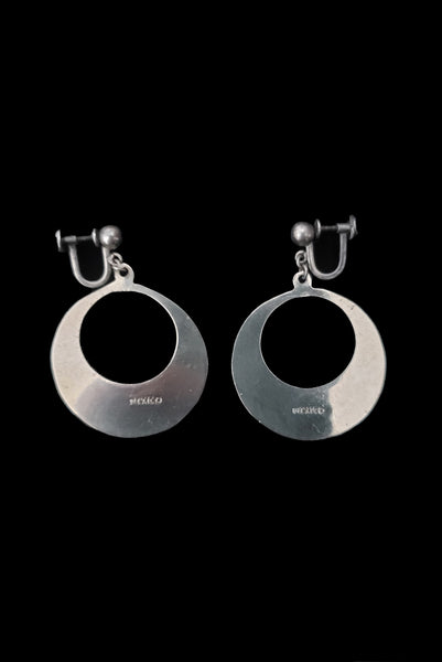 Vertical back view of 1950s vintage alpaca silver and white abalone shell inlaid in black drop hoop screw back earrings.