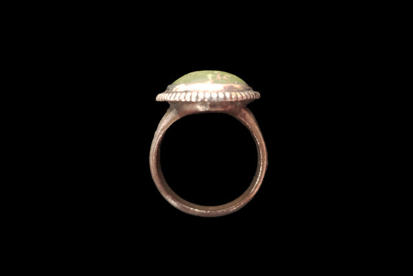 Horizontal top view of 1960s vintage southwestern silver and oval green cabochon mid century ring, size 6.25.