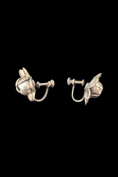 Vertical side view of 1950s vintage 925 sterling silver floral rose screw back earrings.