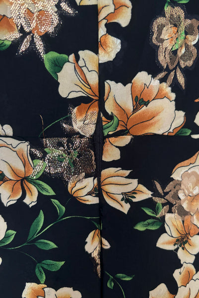 Detail view of vintage 2000s made 1940s reproduction black, yellow, and gold floral silk and lurex evening dress, size medium to large. Showing some pulled lurex threads near the zipper.